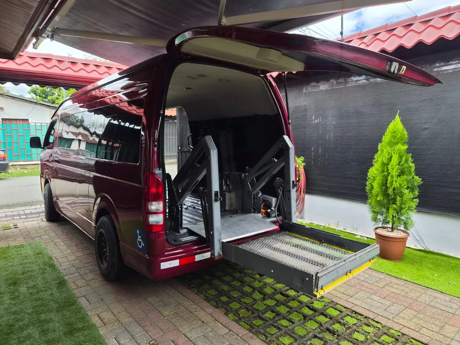 Accessible Taxi Quintavalle van with its hydraulic wheelchair lift extended