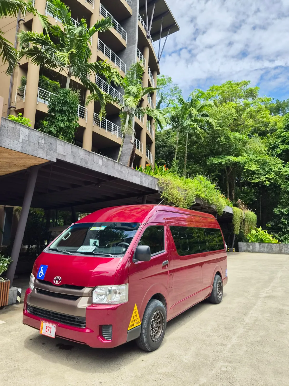 Accessible red Taxi Quintavalle van at a hotel in Manuel Antonio